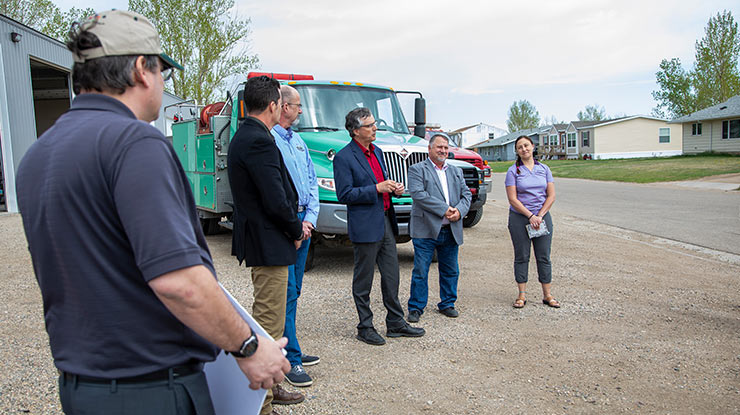 people standing in a line in front of a fire truck