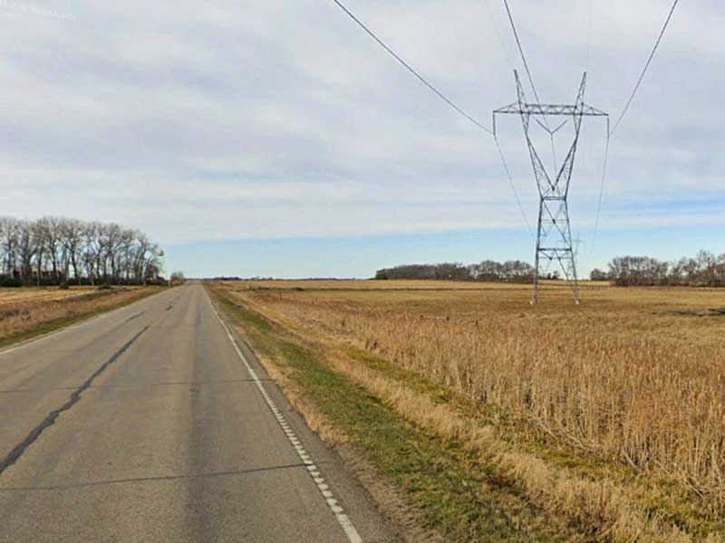 Landscape with road and transmission tower