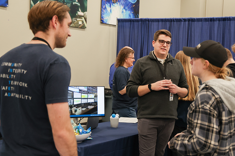 Basin Electric employees visit with student