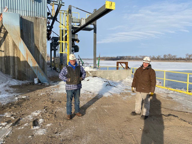 men standing near power plant