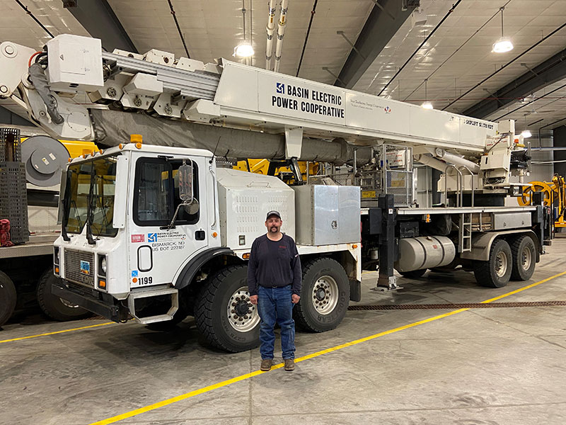 man in front of bucket truck