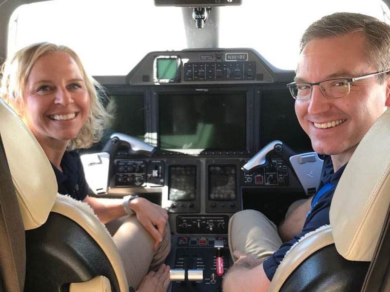 two pilots sitting in the cockpit of a plane