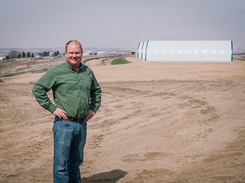 Abe Sandquist stands on the future location of a WINR Center