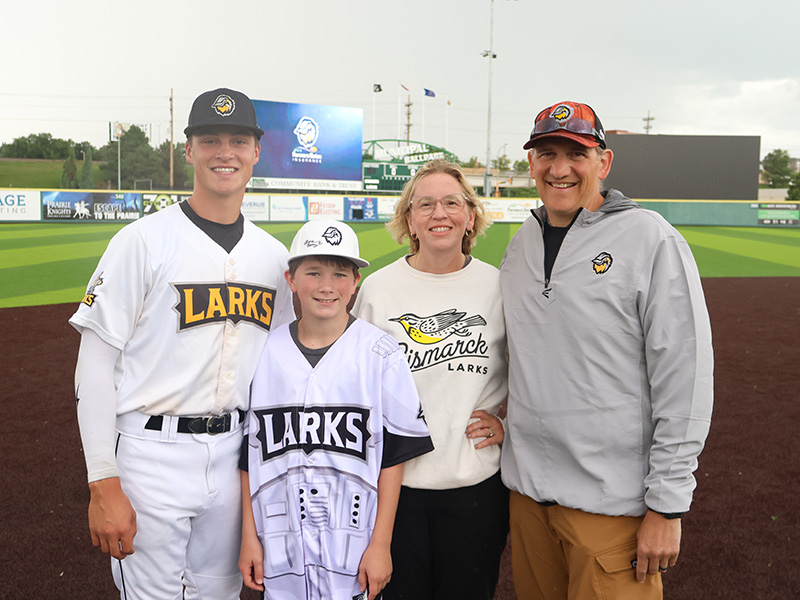Family posing with Larks player