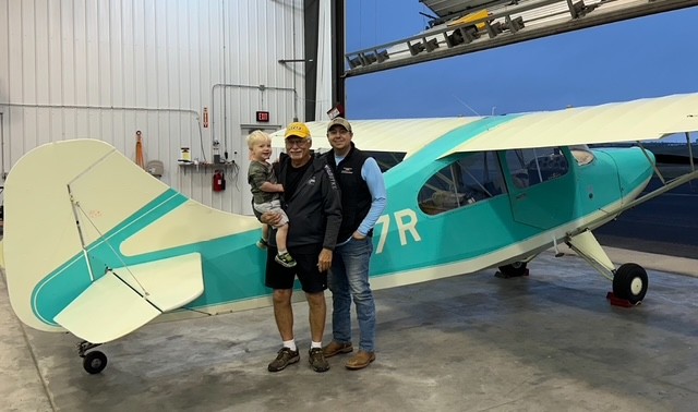 Milo and Jordan by an airplane