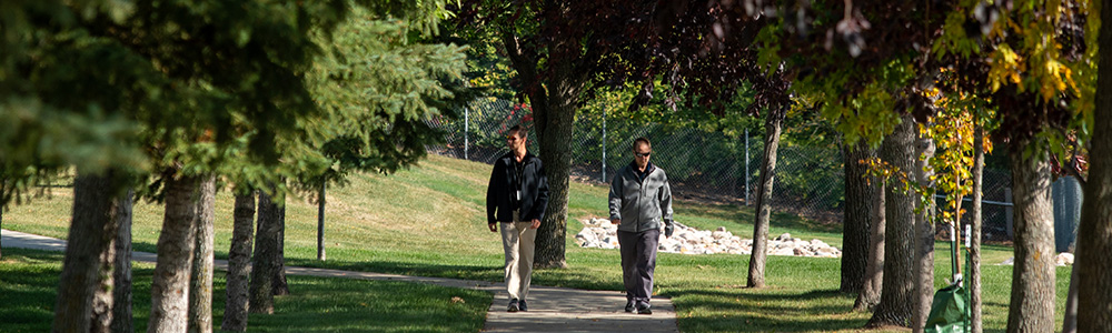 Two employees on the walking path