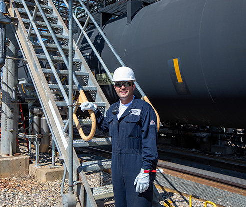 Employee by stairs at Dakota Gas