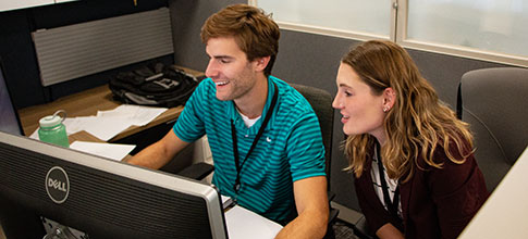 two people working at a computer