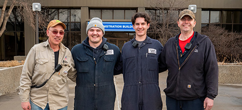 Four men in front of building