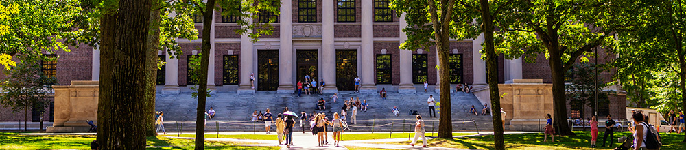 Students on campus in front of large building