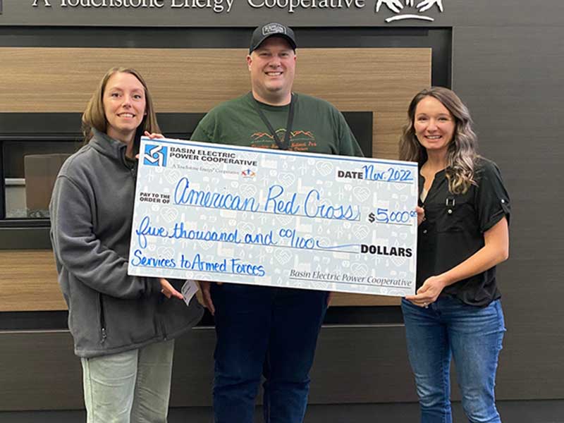 People standing with large check