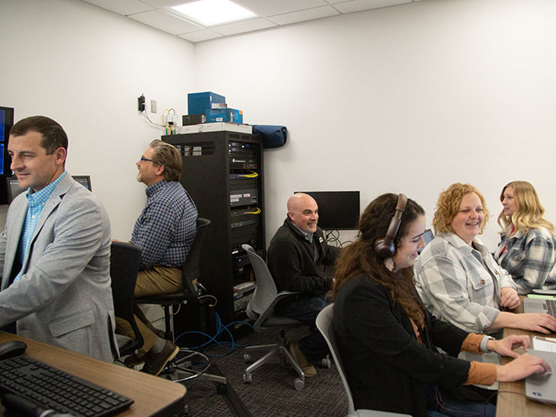 People sitting in a room and working on computers